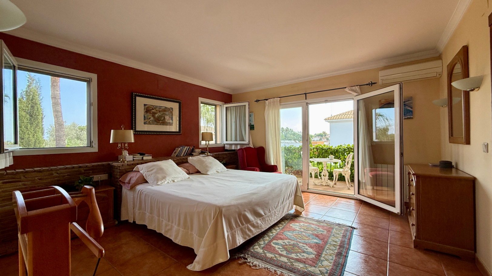 Ruim villa met zwembad, grote kelder en maximale privacy in Dénia Gelegen in een van de rustigste woonwijken van Dénia, combineert deze prachtige villa privacy, ruimte en een uitstekende verbinding met het stadscentrum. Gebouwd op een perceel van 811 m², omgeven door groen, biedt het een verzorgde en besloten omgeving, ideaal om te genieten van de rust zonder in te boeten op alle voorzieningen. De woning beschikt over vier slaapkamers, verdeeld over twee verdiepingen, en ruime, lichte ruimtes die zijn ontworpen voor dagelijks comfort. De keuken, van royale afmetingen, functioneert ook als eetkamer en ontvangt veel natuurlijk licht dankzij de grote ramen. Op de bovenverdieping bevindt zich een aparte kantoorruimte en de hoofdsuite, die beschikt over een eigen badkamer, inloopkast en balkon. Buiten steekt een mooie tuin met eigen bronirrigatie, een zwembad van 9 x 5 meter dat perfect in de omgeving is geïntegreerd, een zomerkeuken en een ruime glazen veranda met open haard, perfect om het hele jaar door van te genieten. De woning beschikt ook over een overdekte garage en ruime buitenruimtes. Een van de grootste aantrekkingskrachten van deze villa is de grote kelder die volledig is ingericht, droog en met uitstekende natuurlijke ventilatie, een zeer veelzijdige ruimte die momenteel een fitnessruimte, speelruimte en biljart bevat, en bovendien de mogelijkheid biedt om een sauna te installeren. De woning is uitgerust met airconditioning in de woonkamer en slaapkamers, een fotovoltaïsche installatie van meer dan 6 kW, alarmsysteem, veiligheidssloten, ramen met inbraakbescherming in verschillende ruimtes, horren, aparte wasruimte, osmosewater in de keuken, een olieopslag van 1.000 liter, aansluiting op het riolering en een compleet drainsysteem dat de kelder beschermt tegen vocht. Een eigendom van uitstekende constructkwaliteit, met ruime binnen- en buitenruimtes, ideaal als permanente woning of om het hele jaar van de Costa Blanca te genieten.